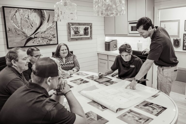 Citadel Enterprises design-build team reviewing remodel plans and drawings with homeowners