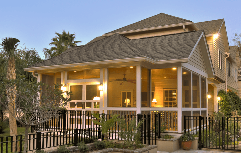 Coastal home addition with screened porch and outdoor living space by Citadel Enterprises