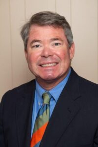 Pete Loy, President and Founder of Citadel Enterprises, smiling in professional attire, showcasing expertise in home remodeling.