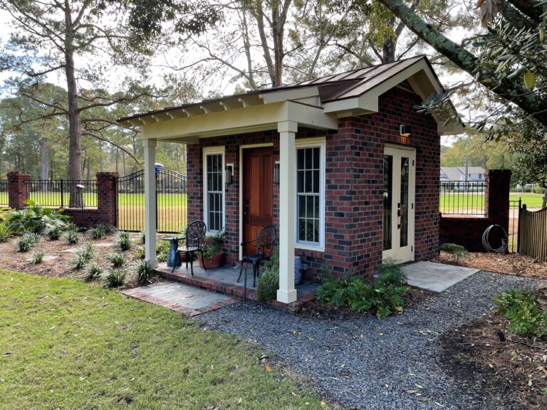 Brick backyard cottage ADU with covered front porch built by Citadel Enterprises