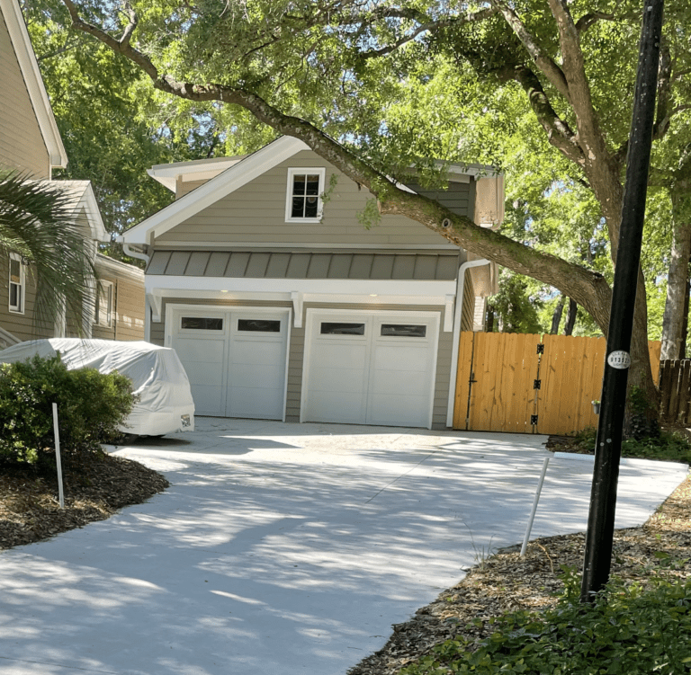 Detached two-car garage with second-story living space built behind a Charleston-area home